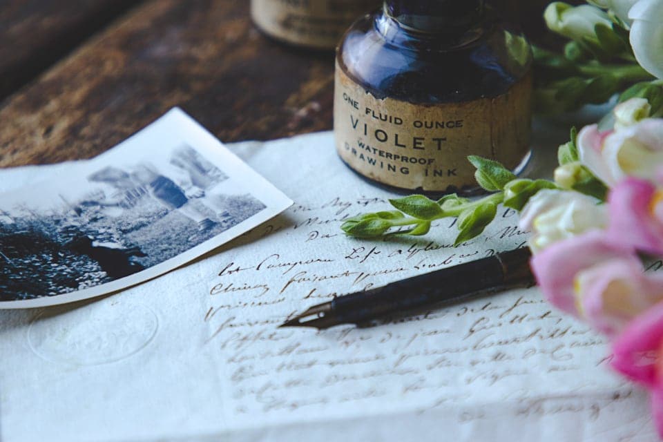 Handwritten letters, an ink pot and an old photograph